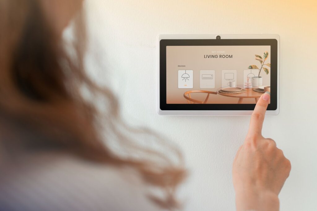 Woman using control panel for living room in smart house